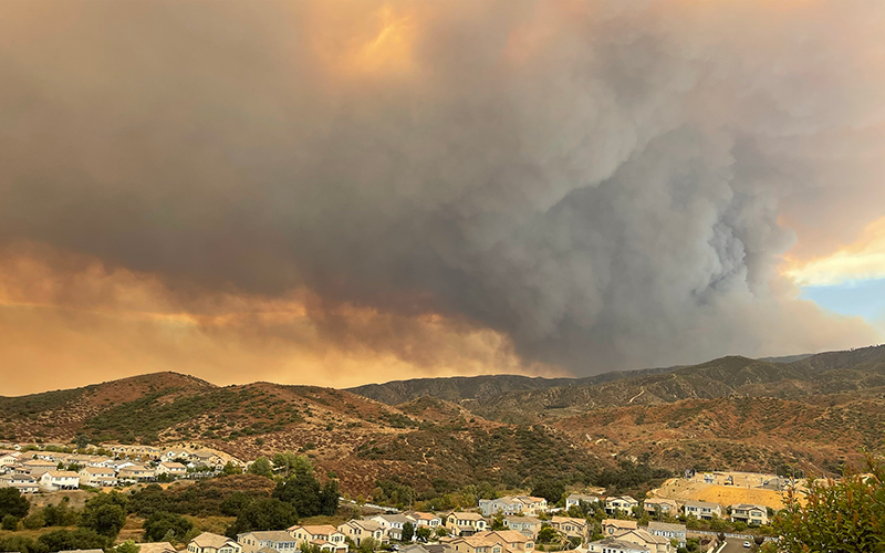 socal hillside with brushfire and poor air quality